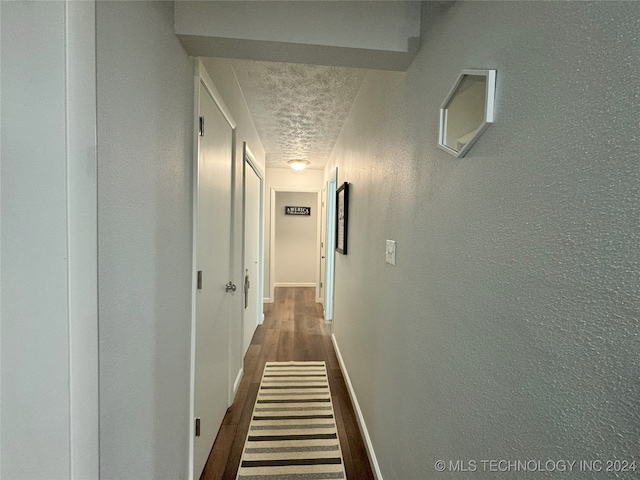 1335 N Mcfarland Pl, Claremore, OK 74017 - corridor with a textured wall, a textured ceiling, and dark wood finished floors