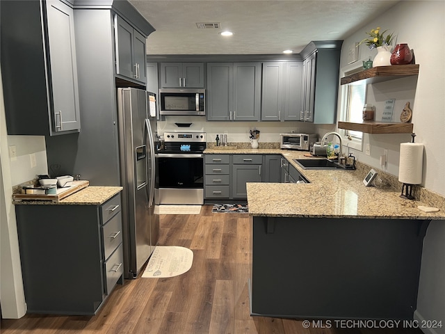 1335 N Mcfarland Pl, Claremore, OK 74017 - kitchen featuring appliances with stainless steel finishes, a peninsula, light stone counters, and recessed lighting
