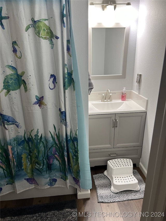 1335 N Mcfarland Pl, Claremore, OK 74017 - full bathroom with wood finished floors, vanity, and a shower with shower curtain