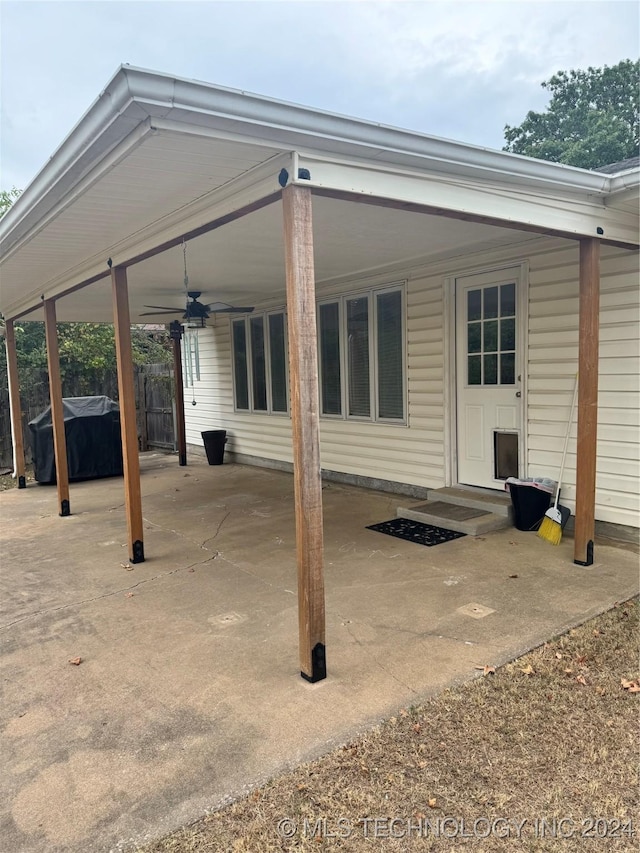 1335 N Mcfarland Pl, Claremore, OK 74017 - rear view of house with ceiling fan, a carport, and a patio