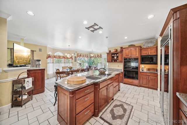 kitchen with a kitchen island, a kitchen breakfast bar, hanging light fixtures, ornamental molding, and black appliances