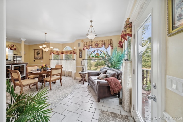 sunroom / solarium featuring a notable chandelier