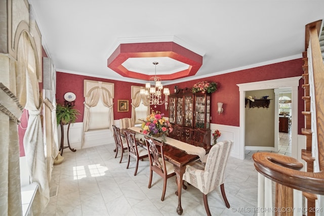 dining space featuring a notable chandelier and ornamental molding