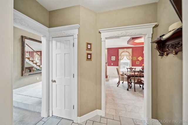 corridor with light tile patterned floors