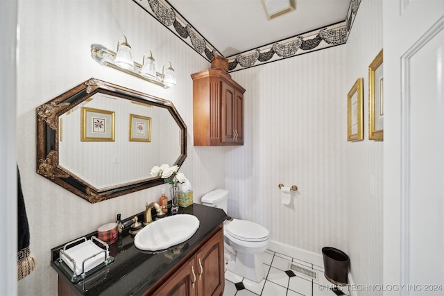 bathroom with vanity, toilet, and tile patterned flooring