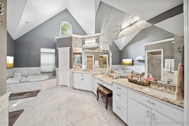 bathroom featuring vanity, shower with separate bathtub, and high vaulted ceiling