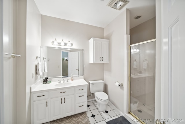 bathroom with a shower with door, toilet, tile patterned floors, and vanity