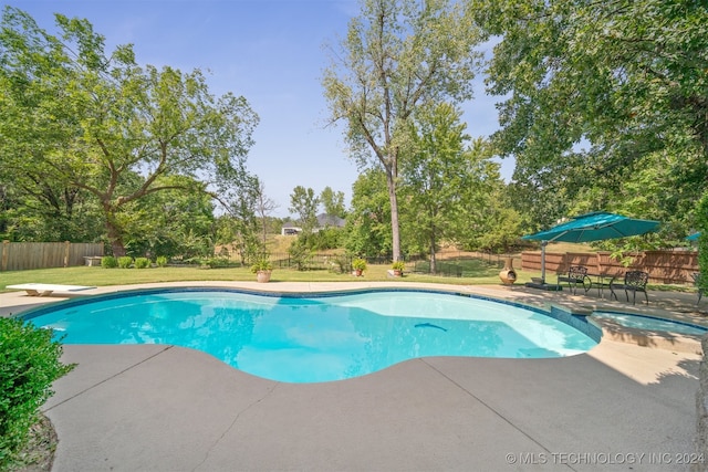 view of pool featuring a patio area, a lawn, and a diving board