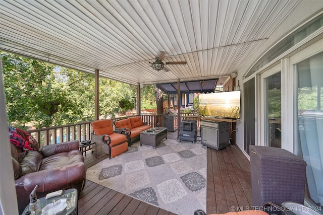 wooden deck featuring an outdoor living space and ceiling fan