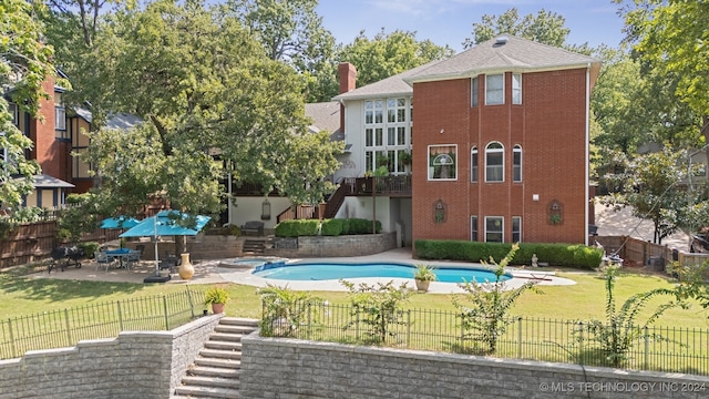 view of pool featuring a patio area and a yard