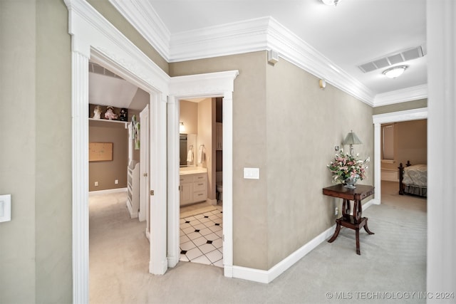 hallway featuring ornamental molding and light colored carpet