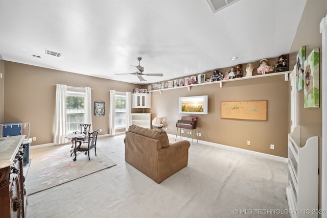 carpeted living room featuring ceiling fan