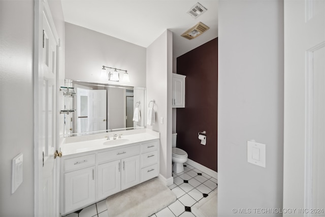 bathroom with vanity, toilet, and tile patterned flooring