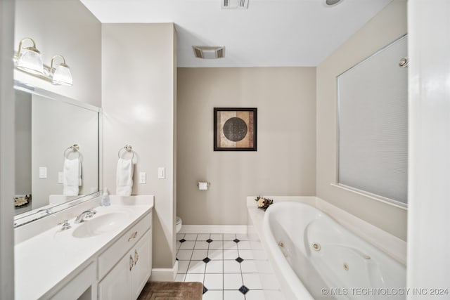 bathroom featuring vanity, a relaxing tiled tub, toilet, and tile patterned floors