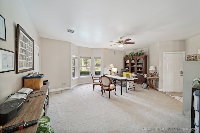 carpeted dining room featuring ceiling fan