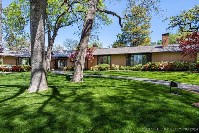 ranch-style house with a front lawn