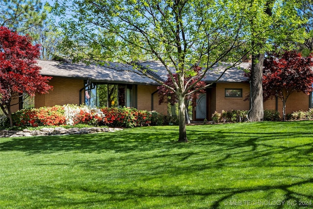 ranch-style house with a front lawn