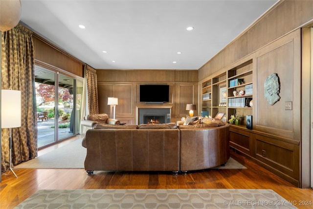 living room with wooden walls and dark hardwood / wood-style flooring