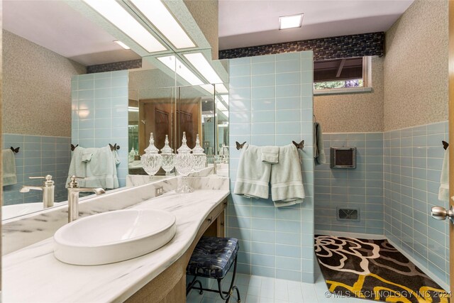 bathroom featuring tile walls and vanity