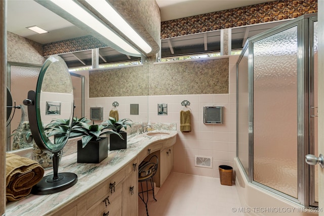 bathroom with vanity, tile walls, tile patterned flooring, and an enclosed shower