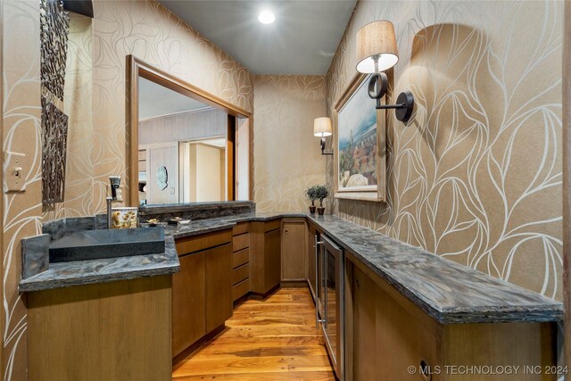 bathroom featuring vanity, hardwood / wood-style floors, and wine cooler