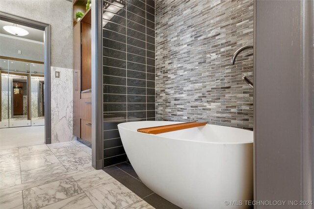 bathroom with a washtub and tile walls