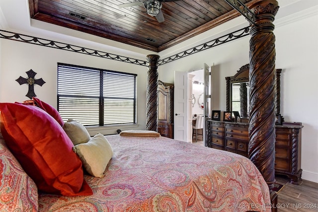 bedroom featuring a raised ceiling, ornamental molding, hardwood / wood-style floors, and wooden ceiling