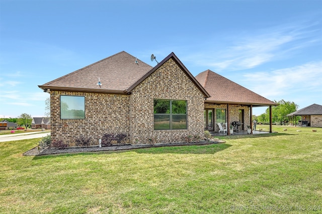 back of house featuring a yard and a patio area