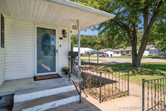 doorway to property with a yard