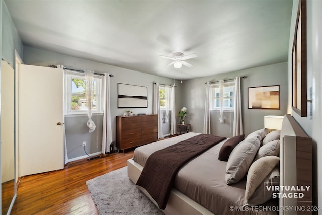 bedroom with wood-type flooring and ceiling fan