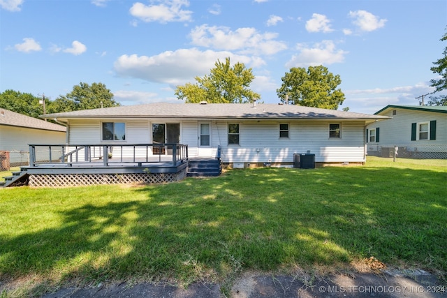 back of house with a yard, a wooden deck, and central air condition unit