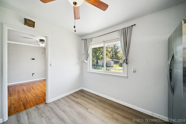 spare room featuring ceiling fan, light hardwood / wood-style floors, and ornamental molding