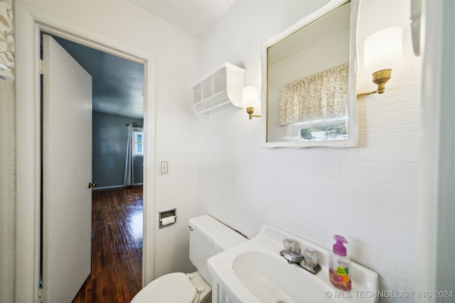 bathroom with hardwood / wood-style floors, toilet, and sink