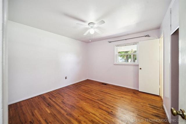 empty room featuring wood-type flooring and ceiling fan