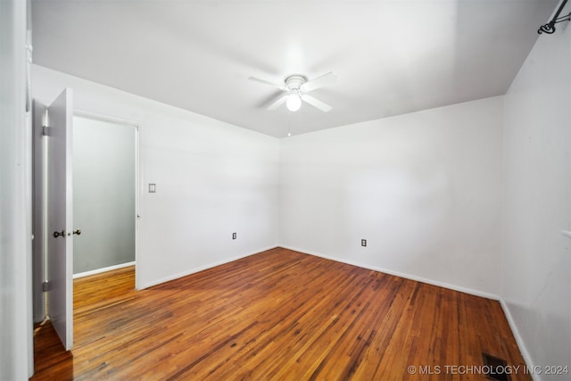 empty room with wood-type flooring and ceiling fan