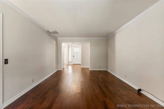 unfurnished room featuring a textured ceiling, crown molding, and dark hardwood / wood-style floors