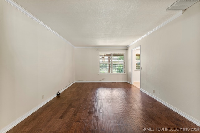 empty room with a textured ceiling, crown molding, and dark hardwood / wood-style flooring