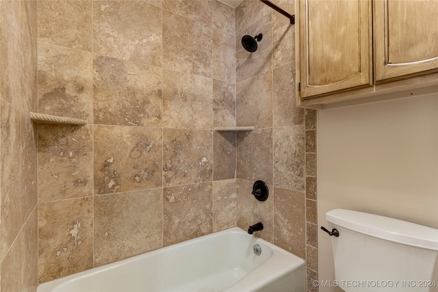 bathroom featuring tiled shower / bath and toilet