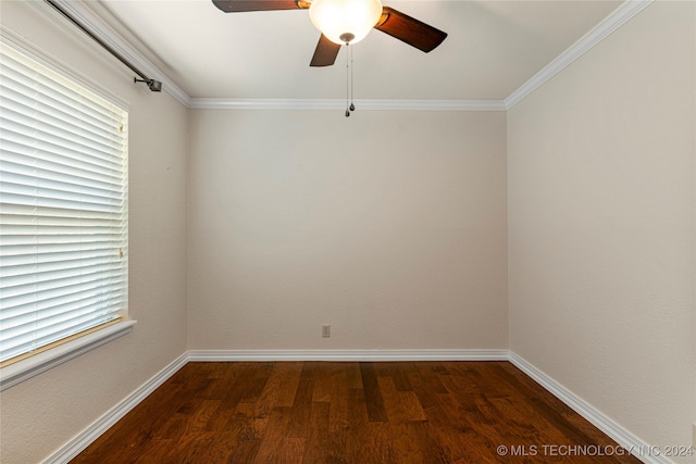 spare room featuring a wealth of natural light, crown molding, ceiling fan, and dark hardwood / wood-style flooring