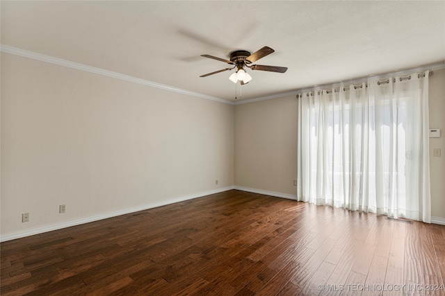 spare room with ceiling fan, a wealth of natural light, dark hardwood / wood-style floors, and ornamental molding