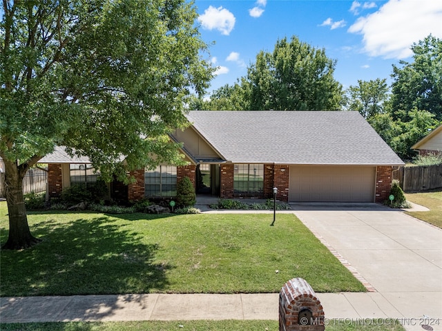 ranch-style home featuring a garage and a front lawn