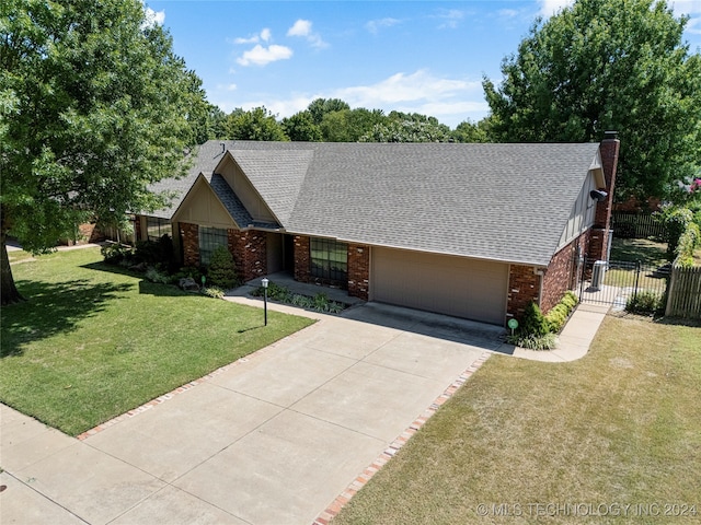 view of front of home with a front lawn and a garage