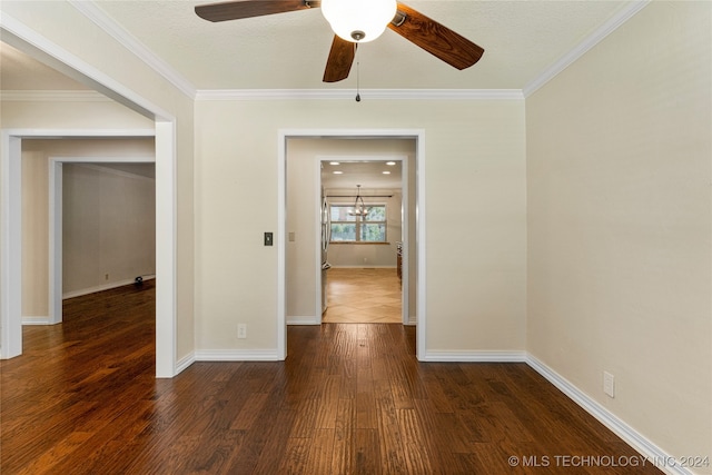 empty room featuring crown molding, ceiling fan, and dark hardwood / wood-style floors