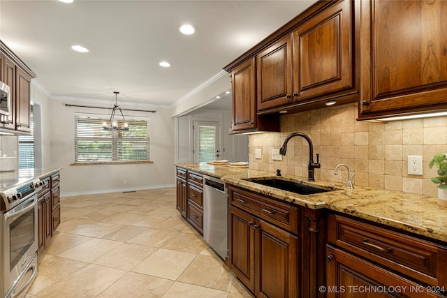 kitchen with backsplash, stainless steel appliances, a notable chandelier, and sink