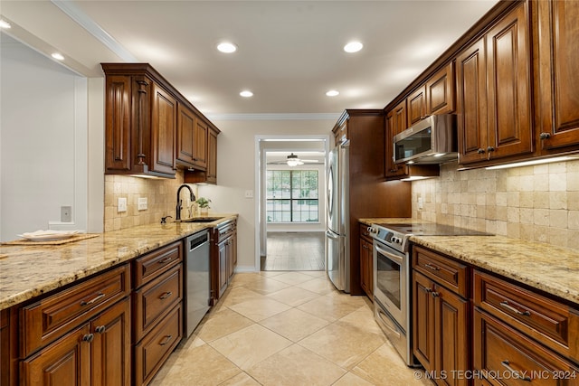 kitchen with light hardwood / wood-style floors, crown molding, stainless steel appliances, sink, and ceiling fan