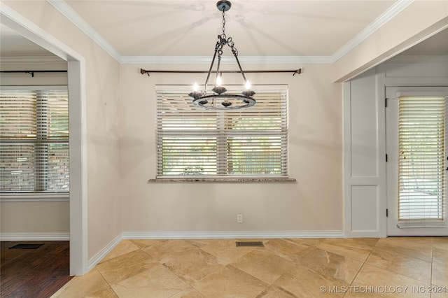 unfurnished dining area featuring an inviting chandelier, crown molding, and light hardwood / wood-style flooring