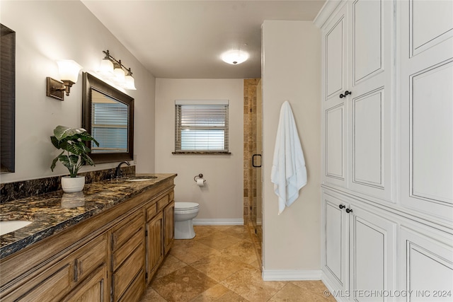 bathroom featuring walk in shower, toilet, and vanity