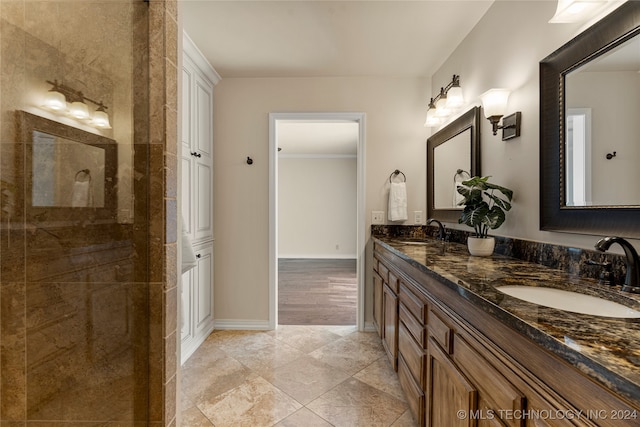 bathroom featuring crown molding, vanity, and a shower