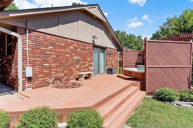 deck featuring a hot tub