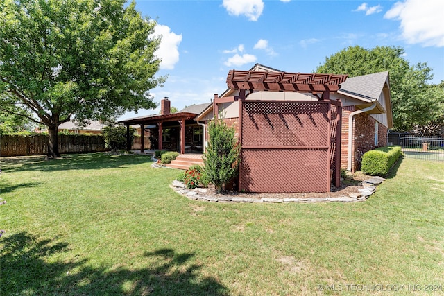 exterior space with a pergola and a lawn